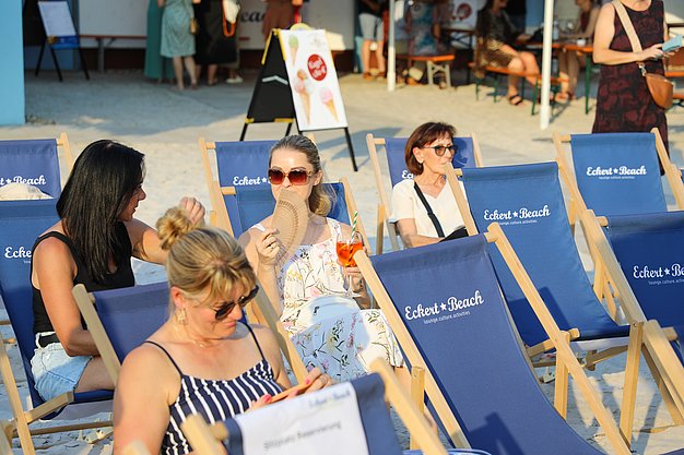 Die Diashow zeigt Eindrücke vom Salsa-Abend am Eckert Beach. Zu sehen sind tanzende Paare, Besucherinnen und Besucher im Publikum sowie die stimmungsvolle Atmosphäre der Veranstaltung am Abend.
