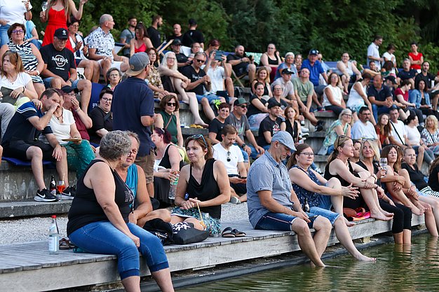 Die Bilder zeigen Eindrücke der Rock-Nacht am Eckert Beach. Zu sehen sind die Live-Auftritte der Bands Rusty Road Runners und ACBarbingCity´25, zahlreiche Besucherinnen und Besucher vor der Bühne sowie die sommerliche Atmosphäre am Strand. In beiden Bands stehen auch Dozenten der Eckert Schulen auf der Bühne. Die Aufnahmen zeigen Musiker, Publikum und die stimmungsvolle Beleuchtung während des Open-Air-Konzerts.