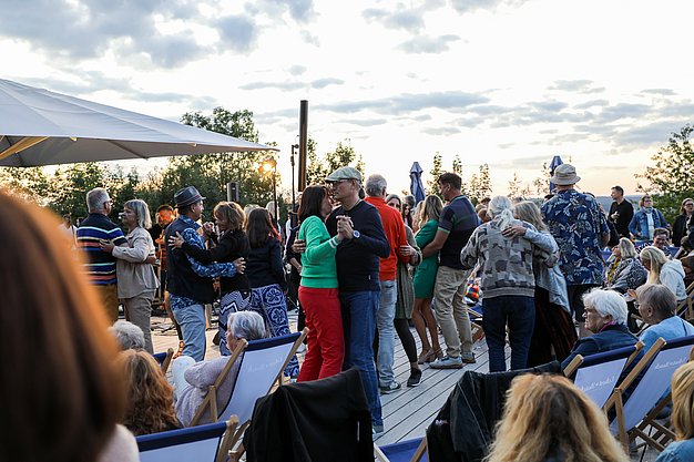 Die Bilder zeigen Impressionen der Notte Italiana am Eckert Beach mit Live-Musik von I CANTAUTORI, zahlreichen Gästen, sommerlicher Atmosphäre, italienischen Spezialitäten sowie entspannten und ausgelassenen Momenten am Wasser.